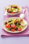 A bean salad with cherry tomatoes, olives and eggs