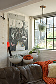 Living room with brown leather sofa and various works of art