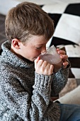 A little boy drinking cocoa