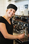 A waitress preparing coffee in a cafe