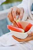 A woman eating watermelon