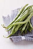 Green beans on a tea towel