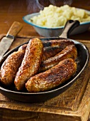 Pork and herb sausages and mashed potato