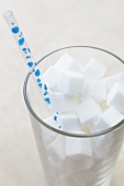 Glass Full of Sugar Cubes with a Straw
