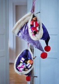 Purple velvet Father Christmas hats filled with presents
