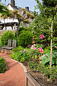 Garden path with plants, flowers and seating area