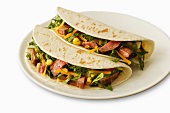 Two Beef Soft Tacos on a White Plate; White Background