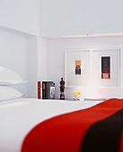 Detail of bedroom with framed pictures above shelf