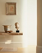 Antique Greek stone head and vessels on table with stone top