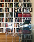 Acrylic glass furniture in front of bookcase
