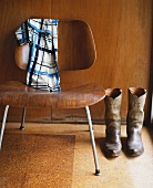 Cowboy boots next to 50s-style chair