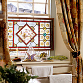 Stained glass window with floral patterns and owl