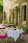 Set table in the courtyard with climbing plants