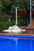 Terrace beyond blue tiled pool