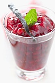 Cranberry sauce with vanilla pod and mint in dessert glass