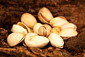 Several pistachios on wood