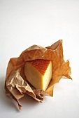 A piece of smoked cheese on paper
