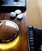 Detail of wooden table with lamp next to leather armchair