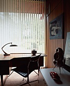 Fifties-style home office with vertical blinds on window