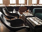 Chairs and old chests functioning as coffee tables in club room