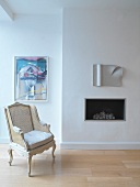 Armchair in front of built-in fireplace