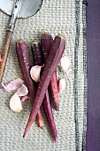 Purple carrots (variety 'Purple Haze') and cloves of garlic