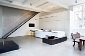 Modern, open-plan kitchen with fitted cupboards & rustic dining table