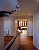 View from hall & stairwell of living room with sofa & armchair