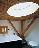 Bathroom with wooden ceiling, wooden beams & round skylight