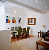 Dining area with table, chairs & paintings