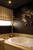 Sunburst mirror above bathtub