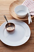 An empty place setting with a saucier