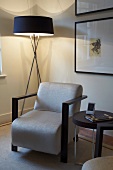 Corner of living room with standard lamp, armchair and side table