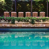 Pool surrounded by planters and deckchairs