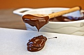 Melted chocolate dripping from a spoon