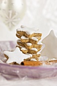 A stack of cinnamon stars on a purple plate