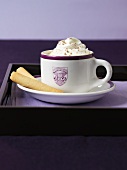 Hot chocolate with cream and wafer rolls