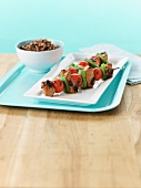Grilled pork kebabs with tomato and pepper