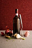 Open bottle of red wine with ingredients & cooking utensils