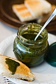 Herb sauce in jar and on slice of toast