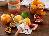 Citrus fruits with reamer, passion fruit and pomegranate
