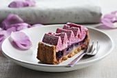 A slice of cherry cake with blueberry cream