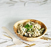 Bowl of Gluten Free Mediterranean Orzo Salad with Feta, Olives and Zucchini