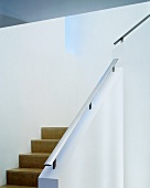 Staircase with masonry balustrade and stainless steel handrail