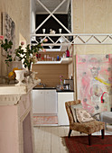 Armchair in front of open doorway with view of kitchen beyond