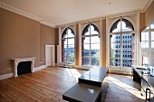 Kitchen island in spacious room with arched windows