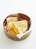 A slice of cake and slices of bread in a tin