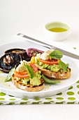 Toasted baguette topped with avocado, hummus and grilled mushrooms