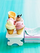 Home-made raspberry ice cream, passion fruit ice cream and chocolate ice cream in cones