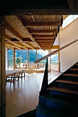 Contemporary wooden house - staircase to gallery in open-plan, light living space with view of mountains